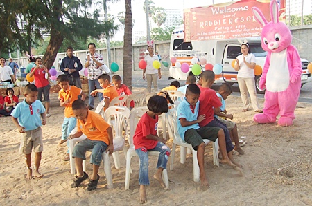 Children scramble for a seat during the musical chairs game.